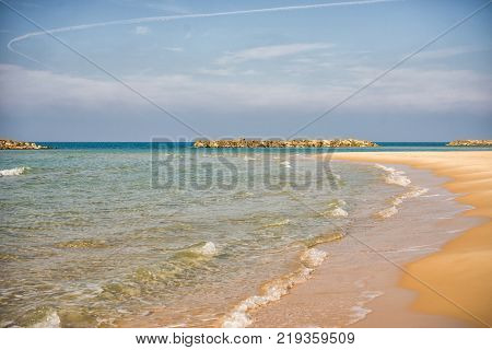 Background. Waves runs over a sandy beach