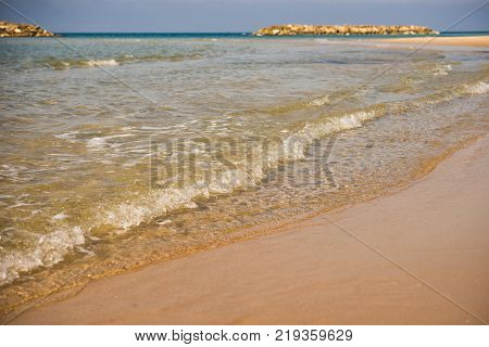 Background. Waves runs over a sandy beach