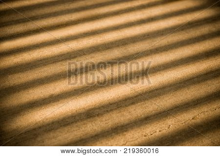Concrete gold abstract background with lined texture