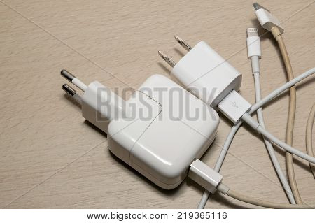 Two white mobile chargers on the table.
