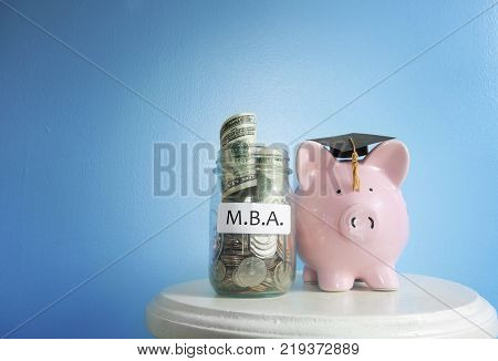 Piggy bank graduate with MBA (Masters of Business Administration) coin jar
