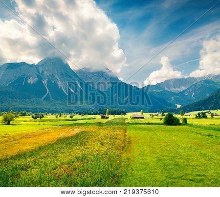 Green meadow on the Golf club Zugspitze Lermoos village loccation. Colorful summer morning in Austrian Alps Reutte district state of Tyrol Austria Europe. Artistic style post processed photo.