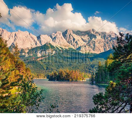 Sunny summer morning on the Eibsee lake with Zugspitze mountain range. Great outdoor scene in German Alps Bavaria Garmisch-Partenkirchen village location Germany Europe.