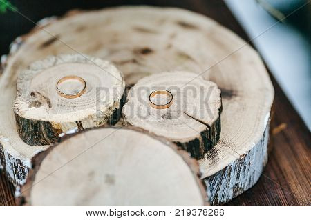 Wedding golden rings on wood cut. atwork, copy space Close-up