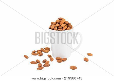 Almond in a white glass isolate on a white background. clipping path