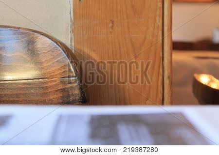 Wooden Chair In Front Of A Table With Light From The Window