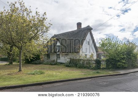Street view of an old thatched cottage in the pretty village of Foxton Cambridgeshire England UK