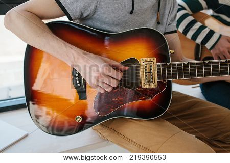 Learning to play the guitar. Music education and extracurricular lessons.