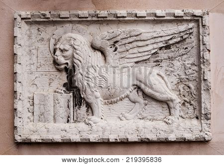 Stone bas-relief of the Venetian lion on one of the houses of Venice. The winged lion of St. Mark is a symbol of the city of Venice, and one of the elements of the flag of the Italian fleet.