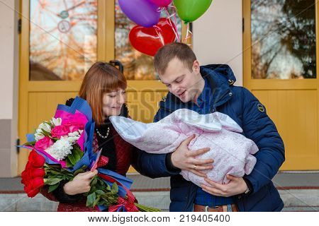 Happy Father Meets His Wife With A Newborn Baby
