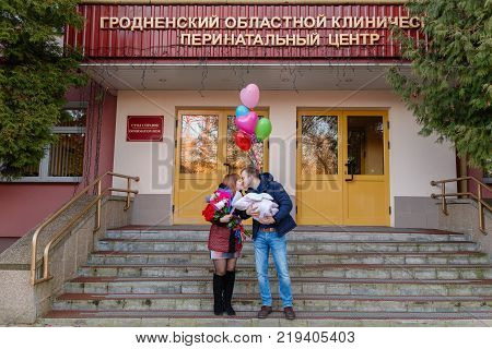 Happy Father Meets His Wife With A Newborn Baby