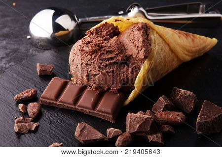 chocolate ice cream scoops with pieces of chocolate and waffle cones