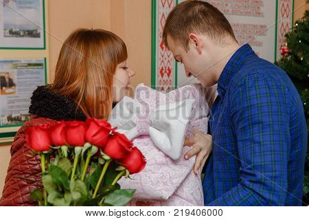 Happy Father Meets His Wife With A Newborn Baby