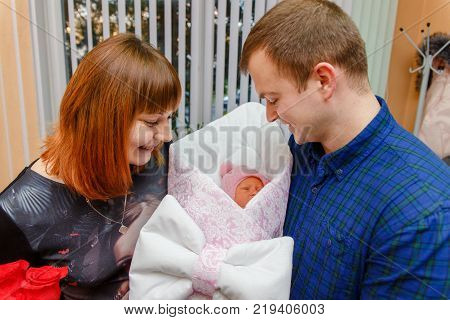 Happy Father Meets His Wife With A Newborn Baby
