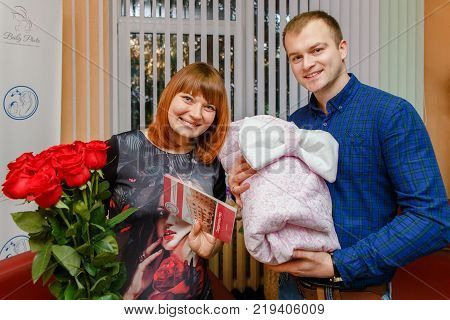Happy Father Meets His Wife With A Newborn Baby