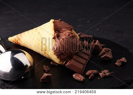 chocolate ice cream scoops with pieces of chocolate and waffle cones