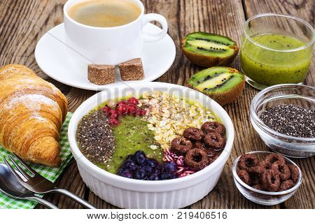 Espresso, croissant and fruit dessert for breakfast. Studio Photo