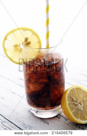 Softdrink With Ice Cubes, Lemon And Straw In Glass