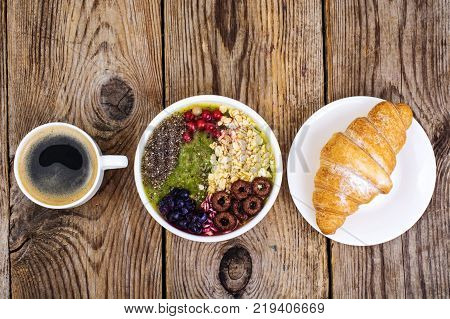 Espresso, croissant and fruit dessert for breakfast. Studio Photo