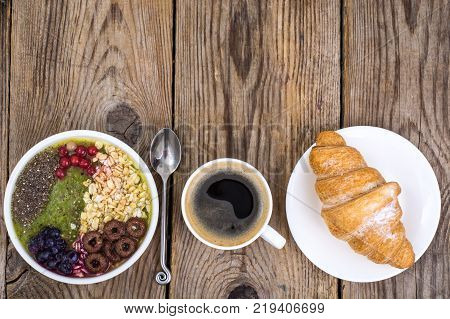 Espresso, croissant and fruit dessert for breakfast. Studio Photo