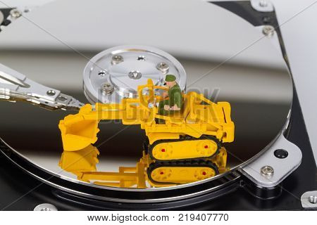 HDD with toy crawler mounted - data security concept.