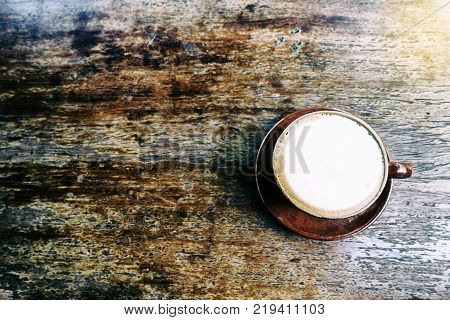 Topdown View Of Cappuccino Coffee On Old Wooden Table With Vintage Effect.
