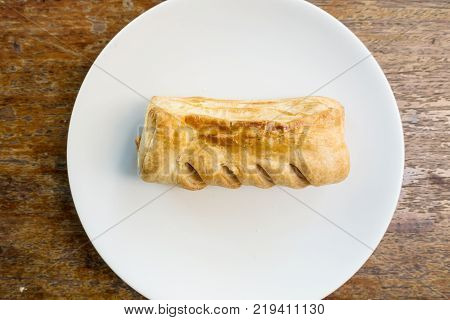 Topdown View Of English Pastry Pie On White Dish On Brown Table. For Breakfast Morning Relaxing News