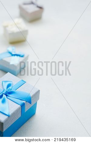 Boy gift on Valentine's Day. Lovely surprise. Blue festive present boxes on white background. Copyspace concept