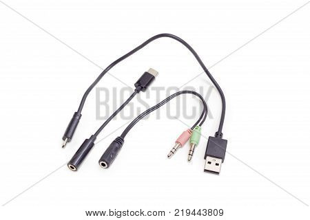 Several different audio and USB cables for connection various gadgets on a white background