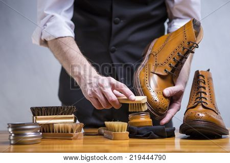 Close Up of Mans Hands Cleaning Luxury Calf Leather Brogues with Special Accessories And Tools. Horizontal Shoot