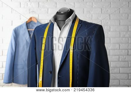 Semi-ready suit on mannequin in atelier