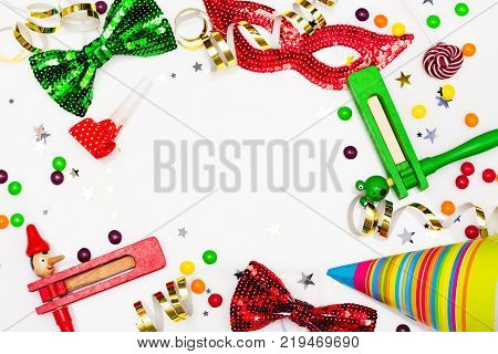 Festive party, carnival or Purim holiday background. Bright hats, masks and confetti on white background. Copy space