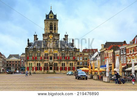 Delft, Netherlands - April 6, 2016: Stadhuis or City Hall, Markt square, houses and people in Delft, Holland