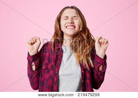 Headshot Of Unhappy Sorrorful Female Curves Lips, Looks Desperately At Camera, Being Upset To Hear B