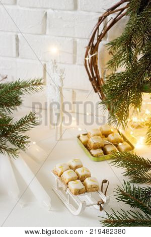 Christmas cookies ginger cubes in festive decoration. Rustic style, selective focus.