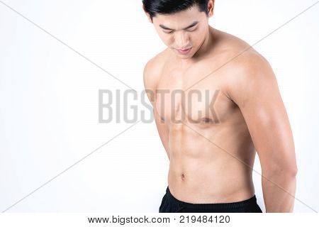 Fitness and health concept. Fit sport man measuring waist to check his body fat amount isolated on w