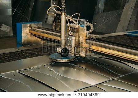 Plasma cut machine cutting steel sheet. Lasercutting  of industrial iron works, toned