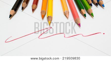 A lots of color pencil on white background with red line