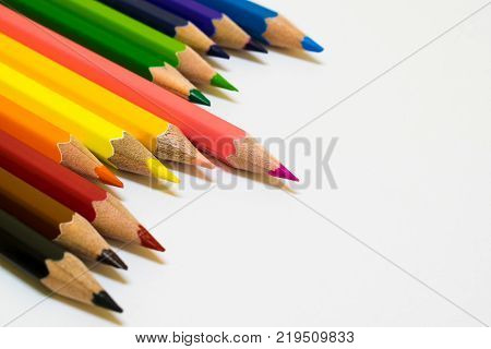 A lots of color pencil on white background and copy space on the right