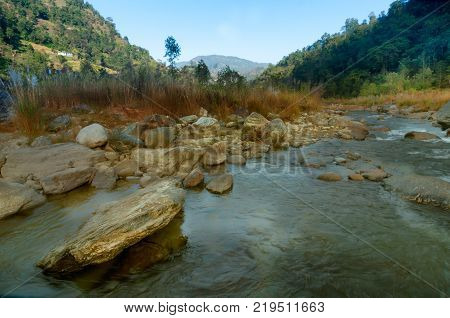 Beautiful Reshi River water flowing through stones and rocks at dawn Sikkim India. Reshi is one of the most famous rivers of Sikkim flowing through the state and serving water to many local people.
