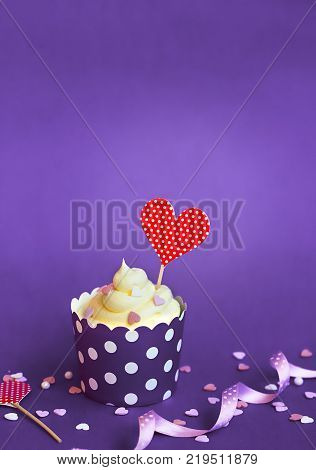 Vanilla Cupcake With Small Decorative Hearts And Red Heart Topper, In Violet Baking Paper Cup, Again