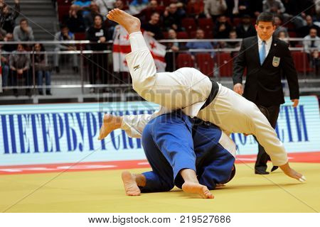 ST. PETERSBURG, RUSSIA - DECEMBER 17, 2017: Final fight Guram Tushishvili, Georgia (blue) vs David Moura, Brazil during Judo World Masters tour. Tushishvili won gold medal