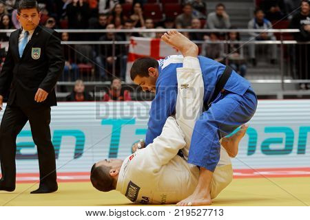 ST. PETERSBURG, RUSSIA - DECEMBER 17, 2017: Final fight Guram Tushishvili, Georgia (blue) vs David Moura, Brazil during Judo World Masters tour. Tushishvili won gold medal