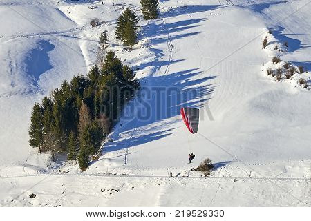 Ischgl, Austria - December 24, 2017: Austrian Alps ski resort Ischgl. Speedrider with red and gray wing skis in close proximity to a steep slope