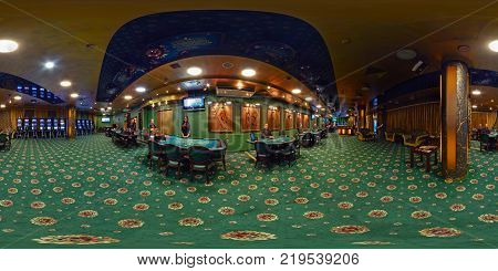 MINSK BELARUS - NOVEMBER 8 2011: panorama of interior in luxury casino шт green style with croupier. Full 360 by 180 degree seamless spherical panorama in equirectangular equidistant projection.