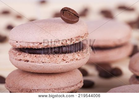 macarons with coffee flavor and coffee beans on white background
