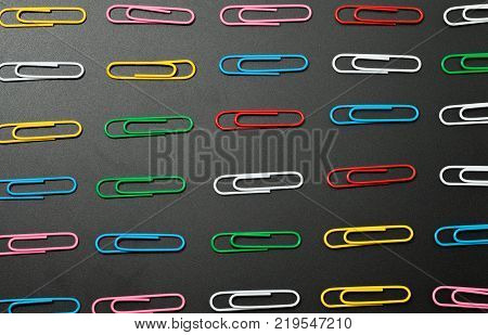 row of paper clip on black background different concept