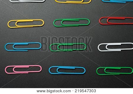 row of paper clip on black background different concept