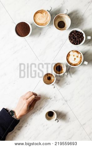 Set of different coffee cups as a question mark, top view , top view. Phylosophy of life concept