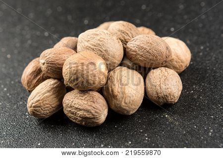 Pile Of Whole Dried Nutmeg Seed For Flavoring